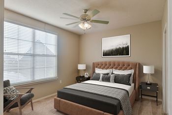 Bedroom with large window and ceiling fan at Harbor Island Apartments, Tennessee